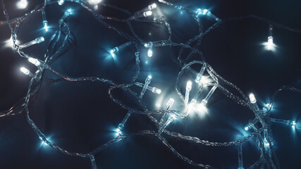 glowing christmas garland with cold light close up soft selective focus macro top view