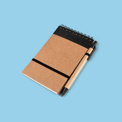 Notebook and pen on blue background.