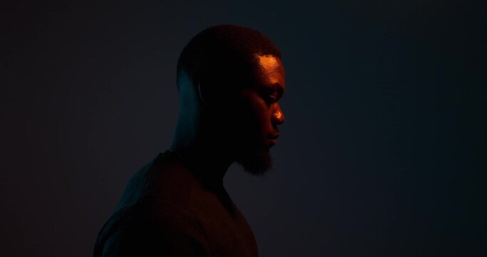 Side view of thoughtful African American man over black background