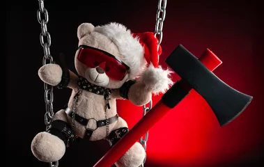 Christmas gift a BDSM teddy bear from a sex shop in a Santa Claus hat with an axe © rotozey