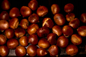 Chestnuts, maroni roasted chestnuts, popular autumn street food in Europe.
