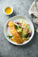 Baked salmon with orange sauce and salad
