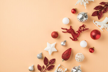 Top view photo of row composition white silver and red christmas tree decorations snowflakes disco balls star cone deer ice skates sleigh and sprigs on isolated beige background with empty space