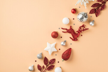 Top view photo of row composition white silver and red christmas tree decorations snowflake disco balls star cone deer sprigs and confetti on isolated beige background with blank space