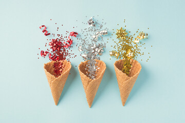 Top view photo of three ice cream cones with christmas decorations explosion of red silver and gold...