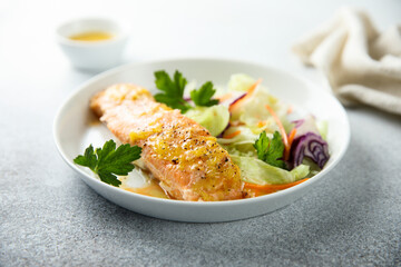 Baked salmon with orange sauce and salad