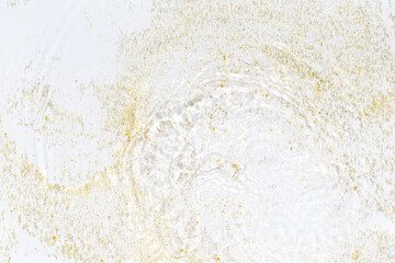 Golden sparkles in water. Gold glitter and liquide texture. Abstract background with golden particles. Shining celebration background. Festive backdrop for your projects.