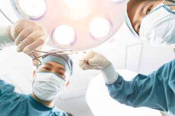 surgeon operating patient with an assistant in the operating room. Surgery and emergency concept