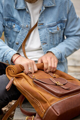 Close up man with leather brown backpack travel, people lifestyle, having handmade accessories. focus on backpack, copy space