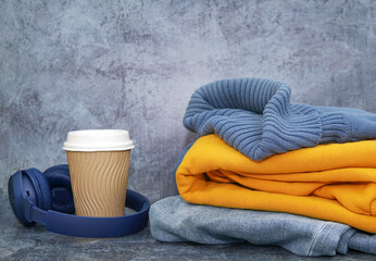 Clothes yellow bag coffee and sneakers on a blue background