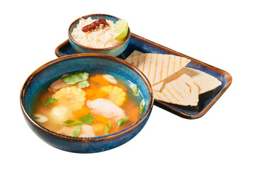 Traditional Mexican chicken soup with vegetables on a white isolated background. Carlo de pollo. Mexican food.