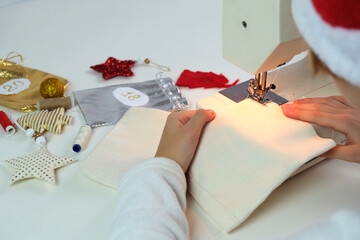 Close up of women hands sewing advent calendar.