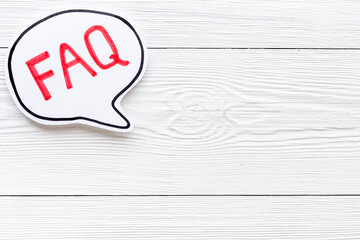Faq - frequently asked questions - text on paper bubble, top view