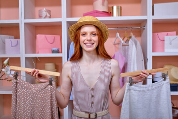 Home closet. positive redhead woman choosing fashion clothing. Shopping concept. Woman having many...