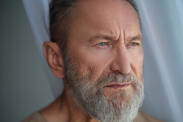 Low-spirited handsome Caucasian man lost in thought