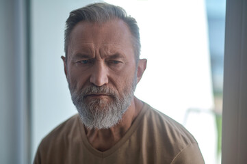 Dejected bearded mature male lost in thought