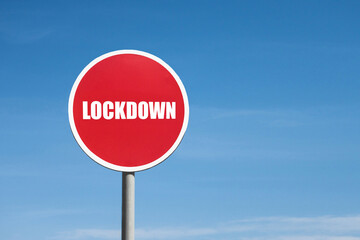 Lockdown sign in red round frame on sky background