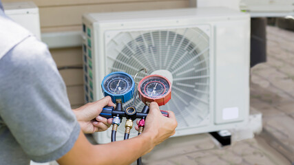Air conditioner technician checks the operation of industrial air conditioners.