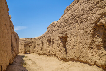 Street in settlement of Buddhist monks on Kara-Tepe hill, Termez, Uzbekistan. Village existed in 1st-4th centuries. Entrances to living and storage areas are visible on sides of walls