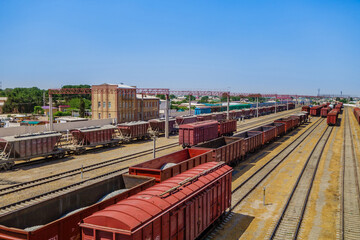 Lines of freight trains stretching into the distance towards the horizon. Railway station of the city of Termez, Uzbekistan