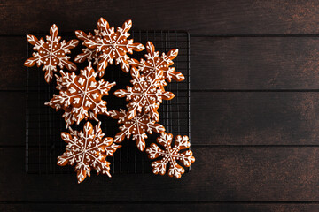 Christmas background with homemade snowflake shape gingerbread cookies on wooden background. New...