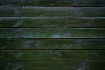 Dark green boards horizontal. Painted wooden planks background. Green wooden background. Natural backdrop. Painted in green boards with knots close-up.