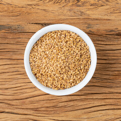 Linseed on a bowl over wooden table