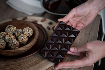 Chocolate in the women's hands. Close-up. Copy space. 
