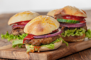 four small hamburges on a board