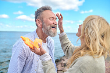 Caring woman with sunscreen and man