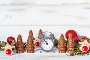 Chocolate Santa Claus and New Year's Alarm Clock.  Celebration Concept for New Year Eve and Christmas.