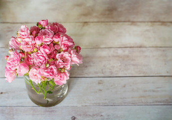 Beautiful Pink Roses Bouquet  on a Wooden Background  