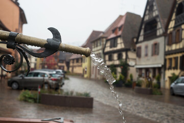 Closeup of retro fountain in the famous village of Bergheim in France