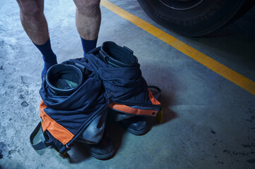 firefighter's boots and trousers grouped together to save time when dressing for an emergency. 