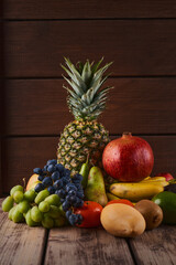 Mix of fresh juicy colorful exotic tropical fruits on wooden background