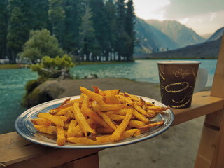 Saifullah Lake, Kalam, Swat, Pakistan - 18 July, 2021: Having a Cup of Coffee and french fries at lake famous not only among nature lovers and escapists but also for the exotic trout fish hunters. 