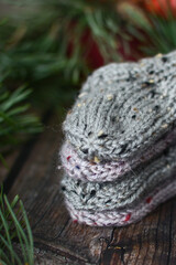 Chunky and warm baby socks o dark wooden background