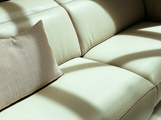Close up detail of cream leather furniture, Sofa with brown pillow.