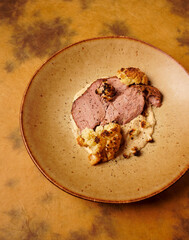 Slowly cooked pork neck, roasted vegetable puree and roasted cauliflower