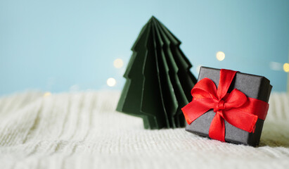 Gift box with paper pine tree. Minimalistic Christmas greeting card. Seasonal shopping. 