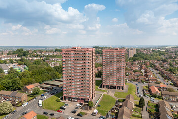 Aerial drone photo of the town of Bramley which is a district in west Leeds, West Yorkshire, England UK, showing residential housing estates, and two blocks of flats and apartments in the summer time - obrazy, fototapety, plakaty