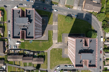 Aerial straight down drone photo of the town of Bramley which is a district in west Leeds, West Yorkshire, England UK, showing residential housing estates and the top apartment blocks in the summer - obrazy, fototapety, plakaty