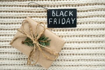 Black Friday big sale promotional sign with handmade gift. Special discount Christmas offer. Advertising message at bags, gift boxes, price tags. Holiday shopping. Flat lay, top view, copy space.