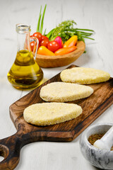 Semifinished homemade zander cutlet on a wooden board