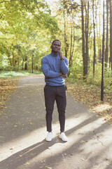 Fototapeta na wymiar African american male student walking in the park