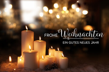 Christmas and new year greeting card with candle lights and golden bokeh at dark night. Background...
