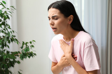 Young woman suffering from breathing problem indoors - obrazy, fototapety, plakaty