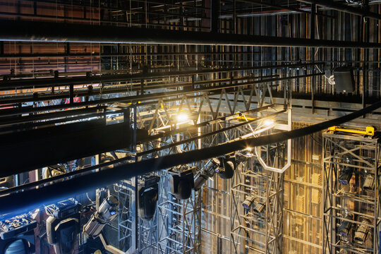 Technical equipment at the backstage of theater. Stage spot lighting rigging structure for a live musical theater events