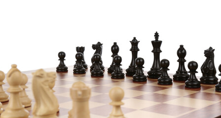 Set of black chess pieces on wooden board against white background