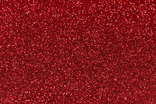 Red sparkling glitter background, christmas abstract shiny texture. Holiday lights